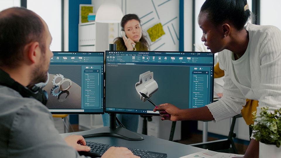 A team collaborating over a computer aided engineering project