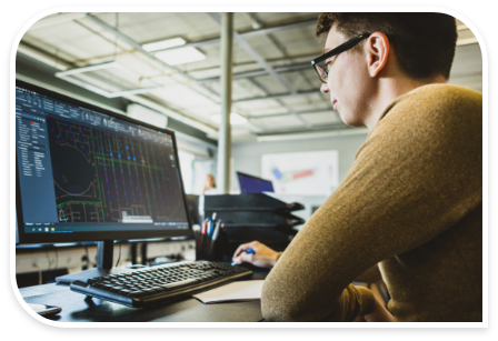 Man sitting at desk looking at schematic